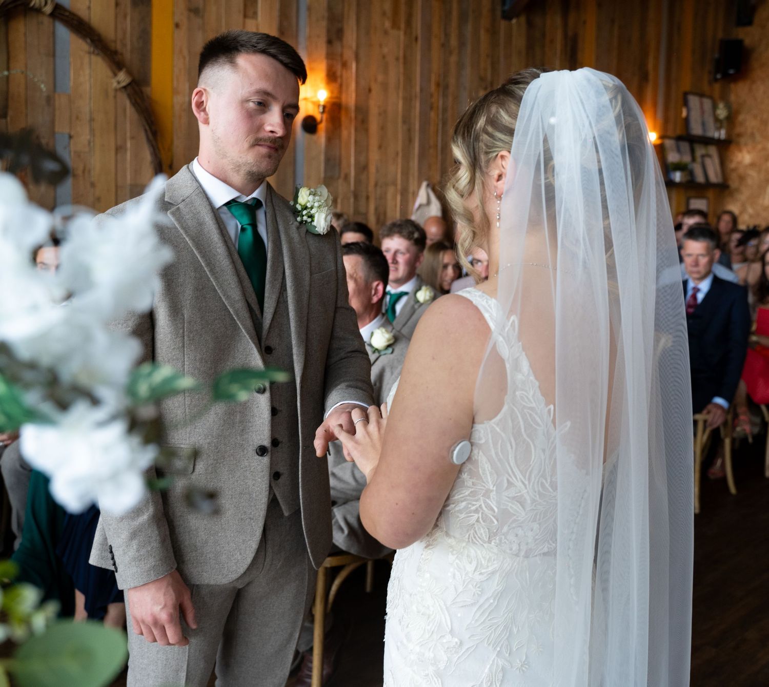 Bride and groom exchanging rings at Little Wold Vineyard, captured by a documentary style photographer in East Yorkshire