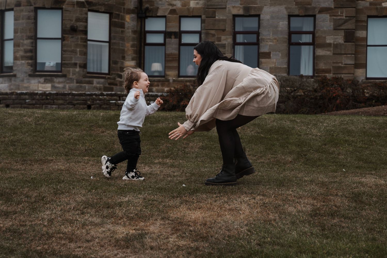 Family laughing and having fun during their engagement shoot, taken by a Yorkshire wedding photographer at Grand villa heights