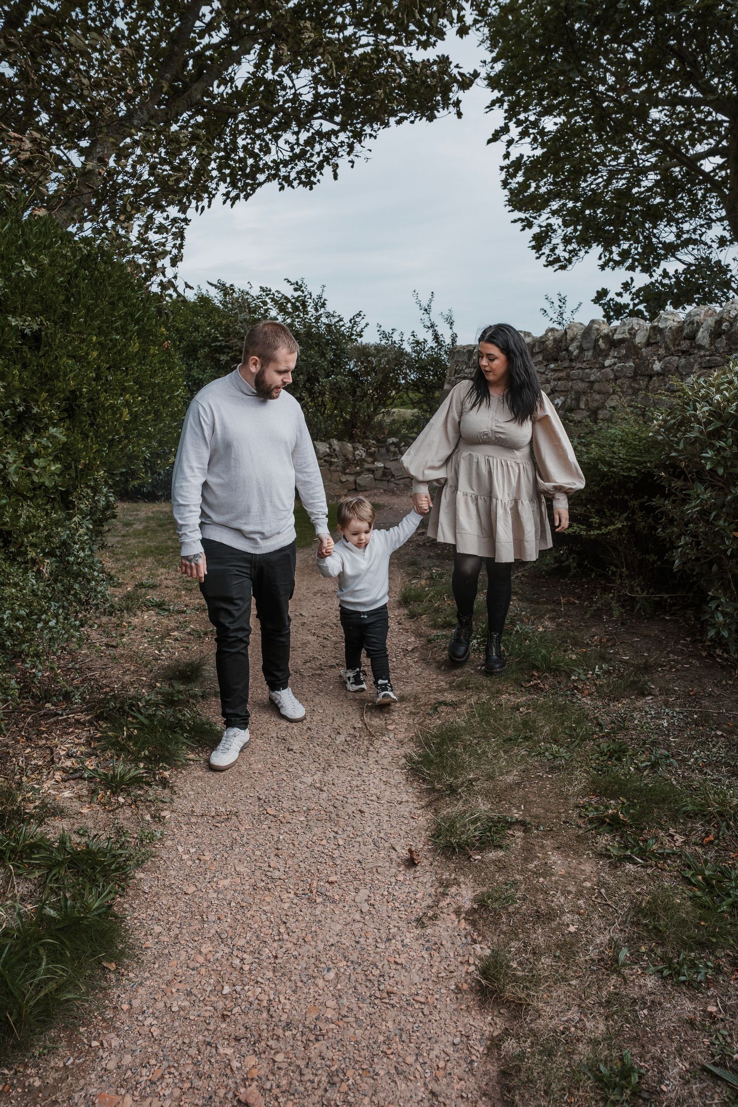 Family laughing and having fun during their engagement shoot, taken by a Yorkshire wedding photographer at Grand villa heights