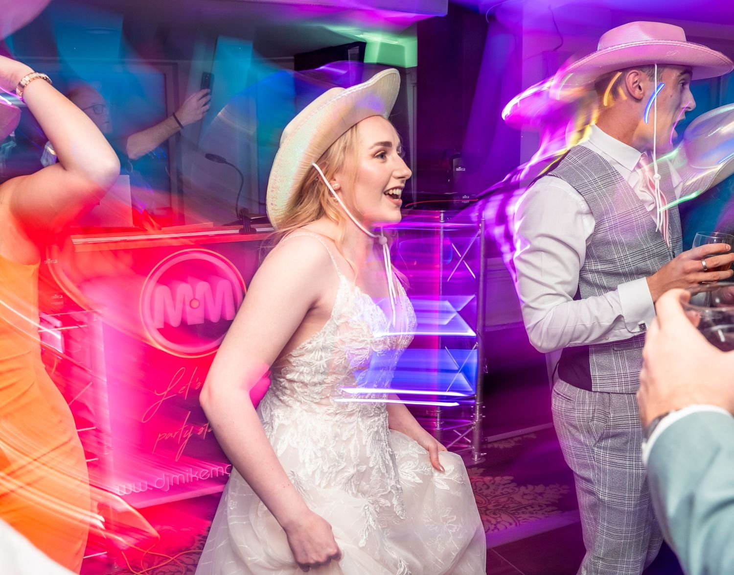 Bride in cowboy hat dancing during her wedding at The Country Park Inn, captured by a candid wedding Photographer