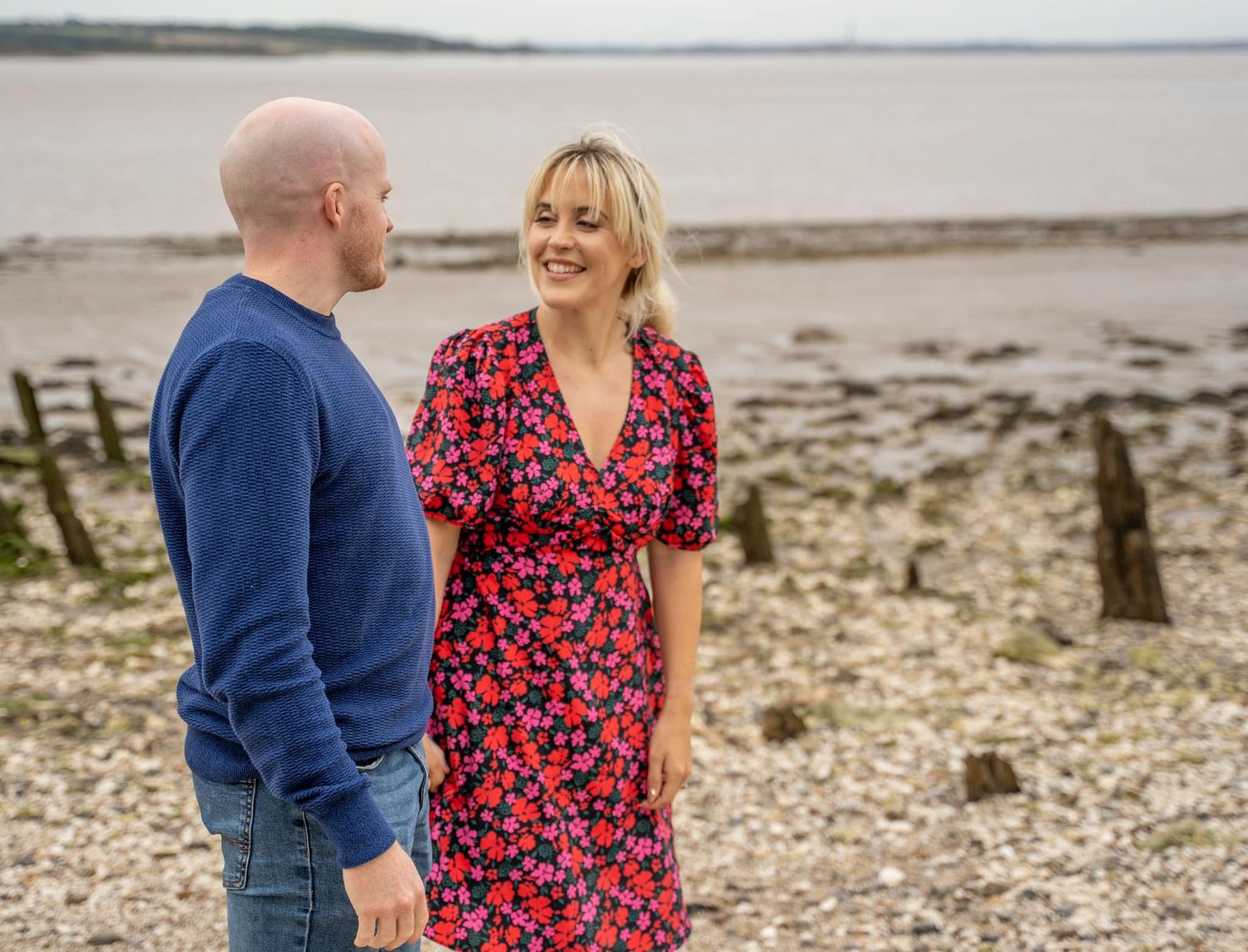 Couple holding hands and smiling during their engagement shoot, taken by a Yorkshire wedding photographer in Hull