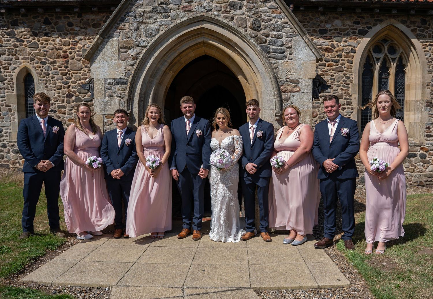 Bride and groom with their bridal party outside of St Elgins church in North Frodingham, captured by Hull wedding photographer