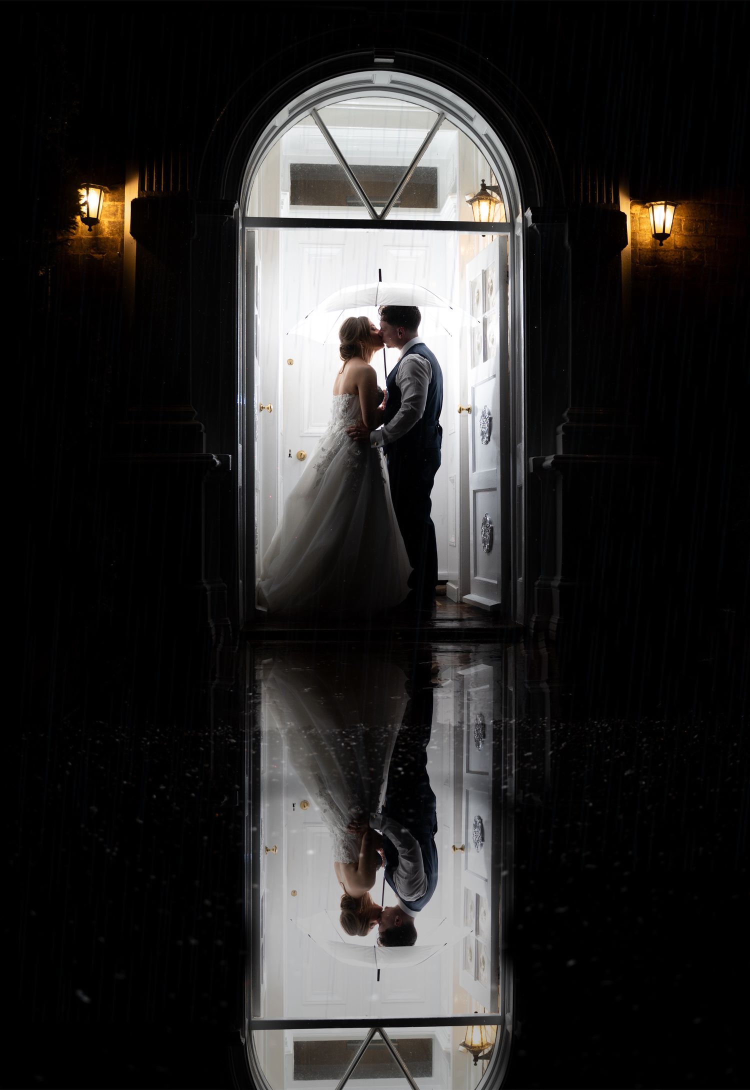 Reflection of bride and groom in the rain at Dunedin country house, captured by a documentary style photographer in East Yorkshire.