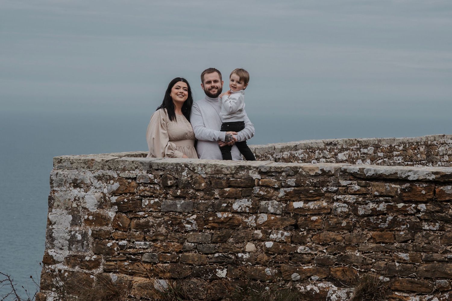 Family smiling and having fun during their engagement shoot, taken by a Yorkshire wedding photographer at Grand villa heights