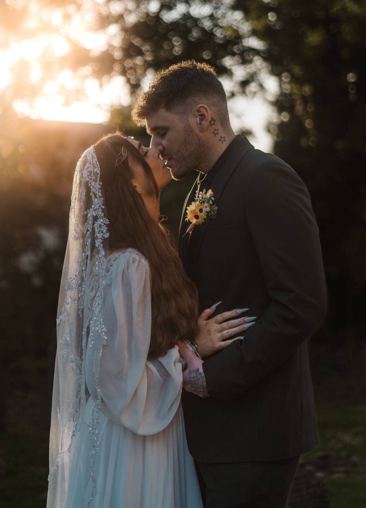 Couple During their wedding at sunset outside of St Nicholas Church, Hornsea. Taken by a wedding photographer in Hornsea east Yorkshire