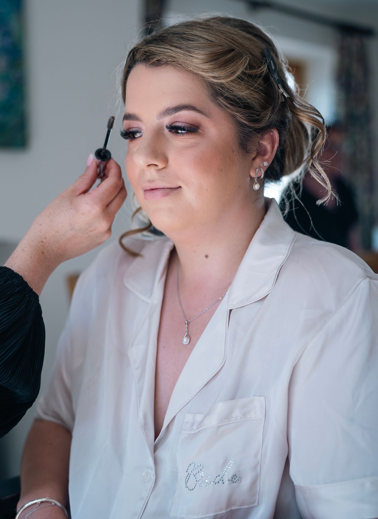 Bride getting her makeup done at her home before her wedding, captured by an East Yorkshire wedding photographer.