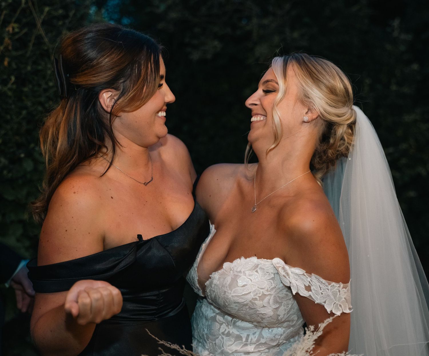 Bride and bridesmaid laughing together at Triton Inn – captured in candid style by East Yorkshire wedding photographer