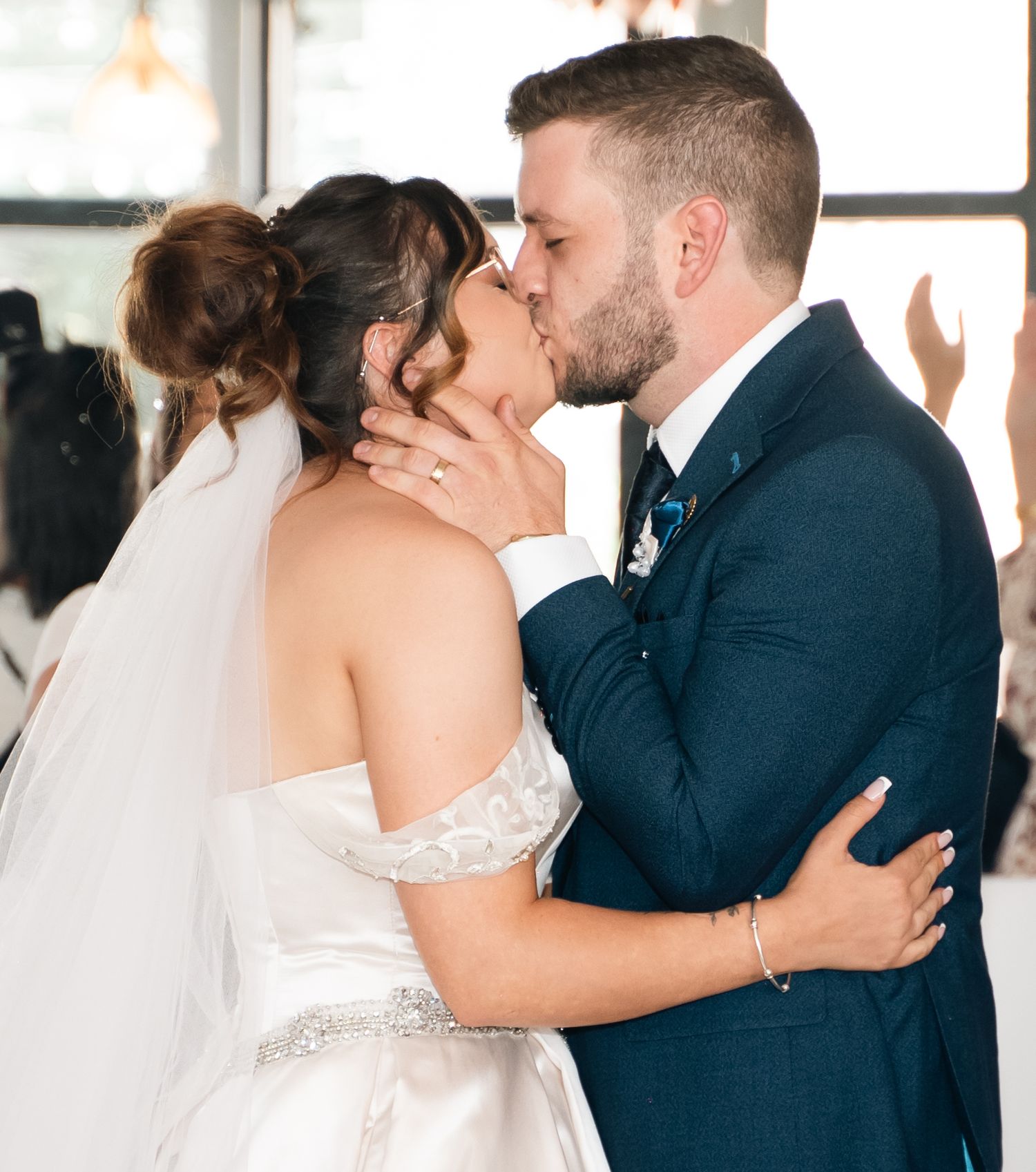 Bride and grooms first kiss as Mr and Mrs at Lazaat Hotel, captured by a documentary style wedding photographer in Hull