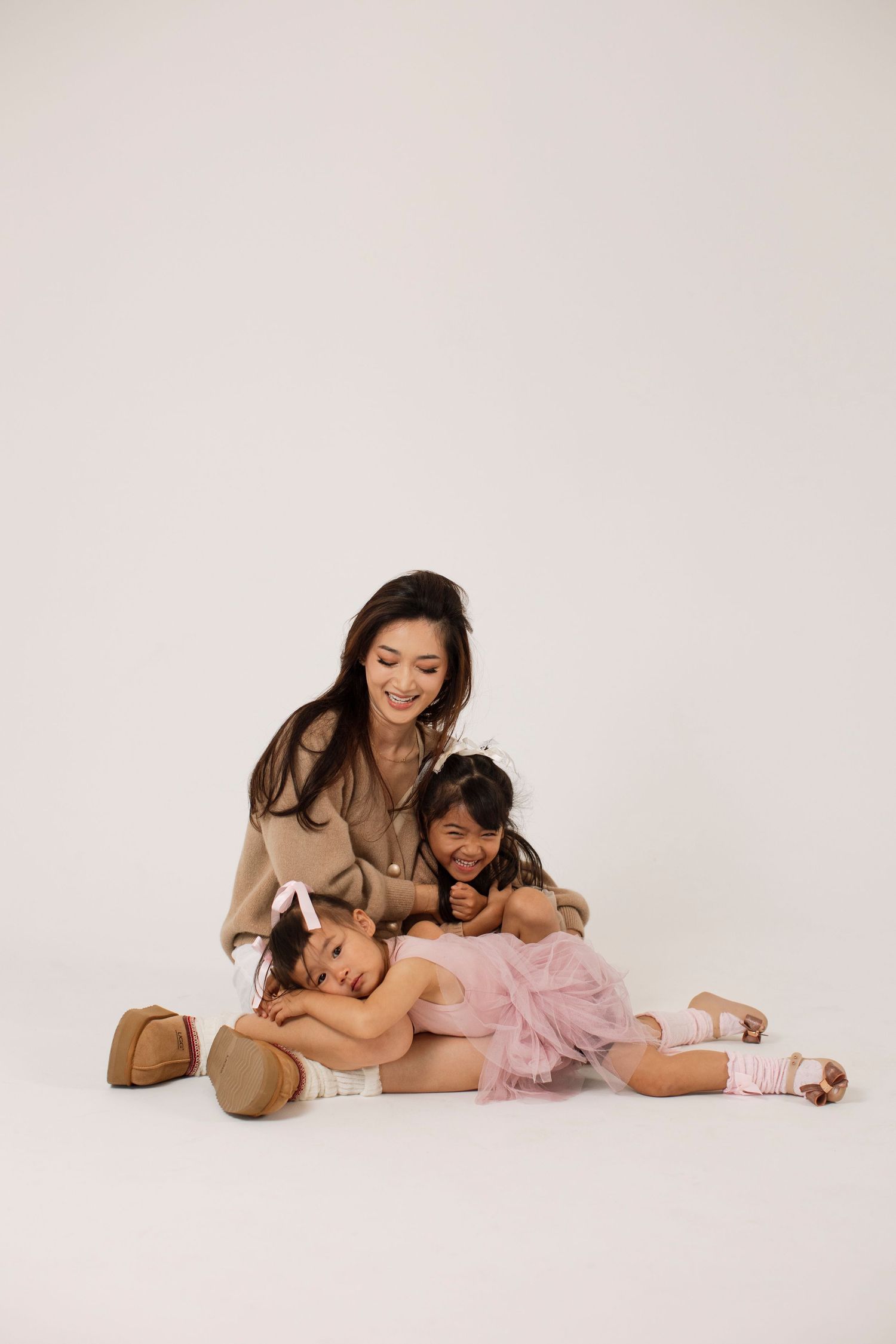 Studio photos showing loving interaction between parent and child in casual attire.