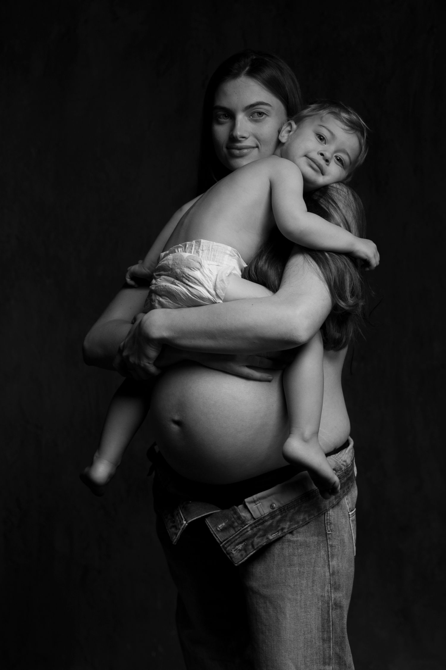 Black and white portrait series captures tender moments between mother and child.