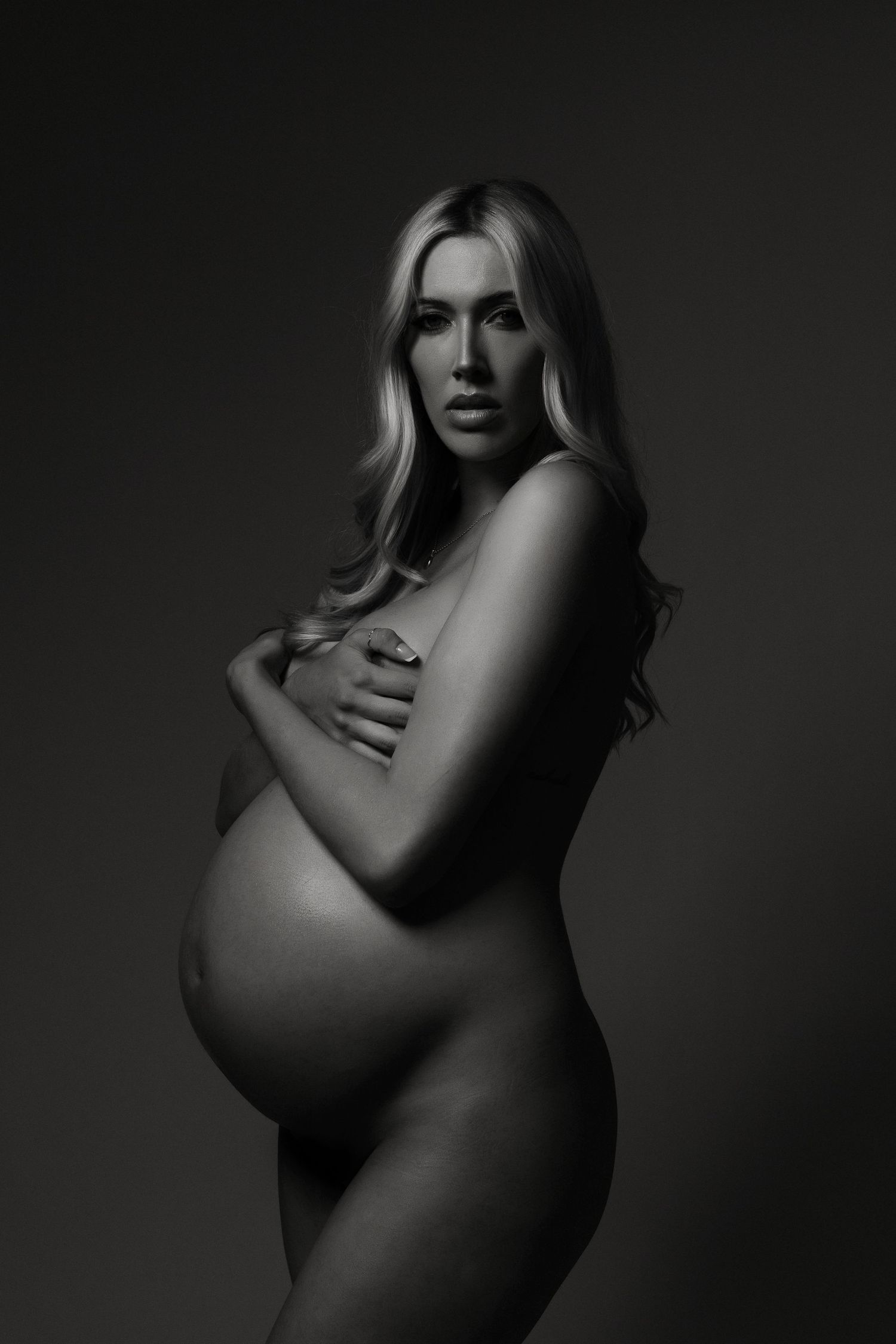Artistic black and white photography series showing silhouetted feminine forms against dark backgrounds.