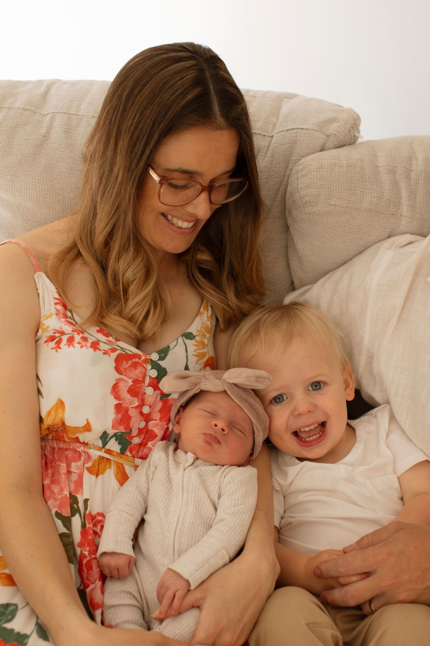 A series of four candid photos showing tender moments between a mother and young children on a beige couch.