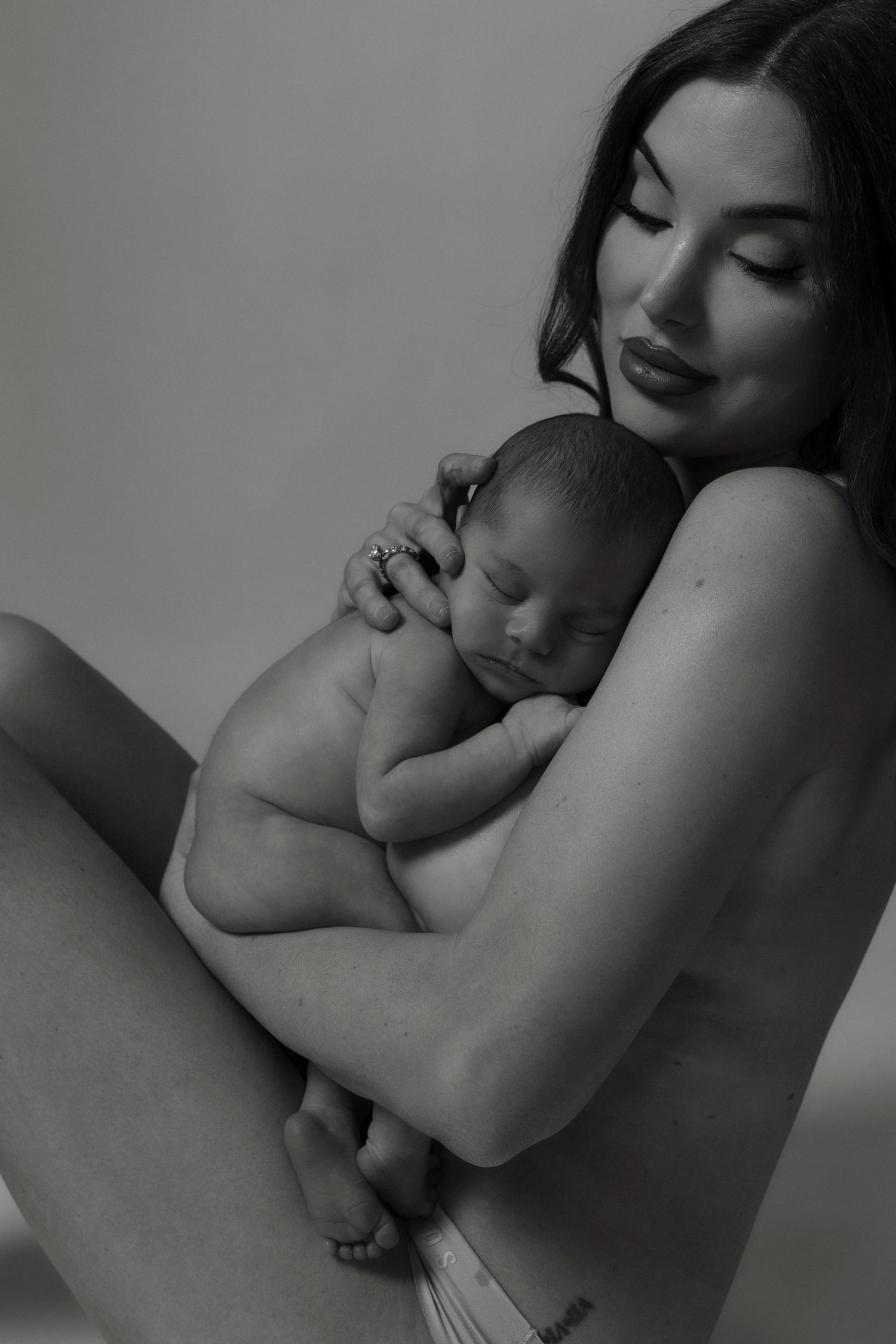 A series of black and white artistic photographs showing intimate embraces and tender moments between two people.