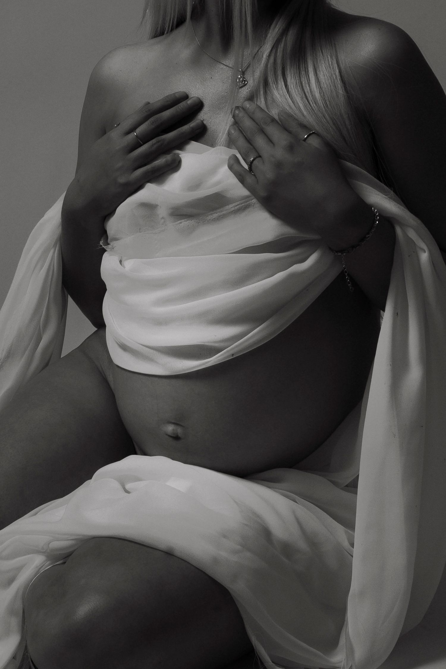 Artistic boudoir series featuring flowing white fabric and dramatic shadows in monochrome.