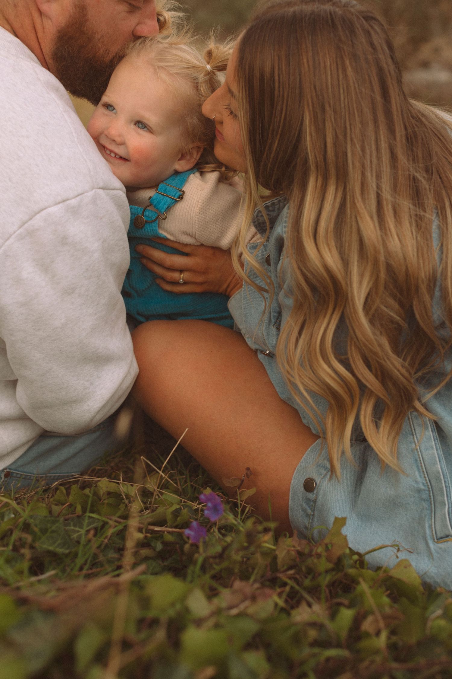 Close-up sequence of intimate family moments captured in a garden setting.