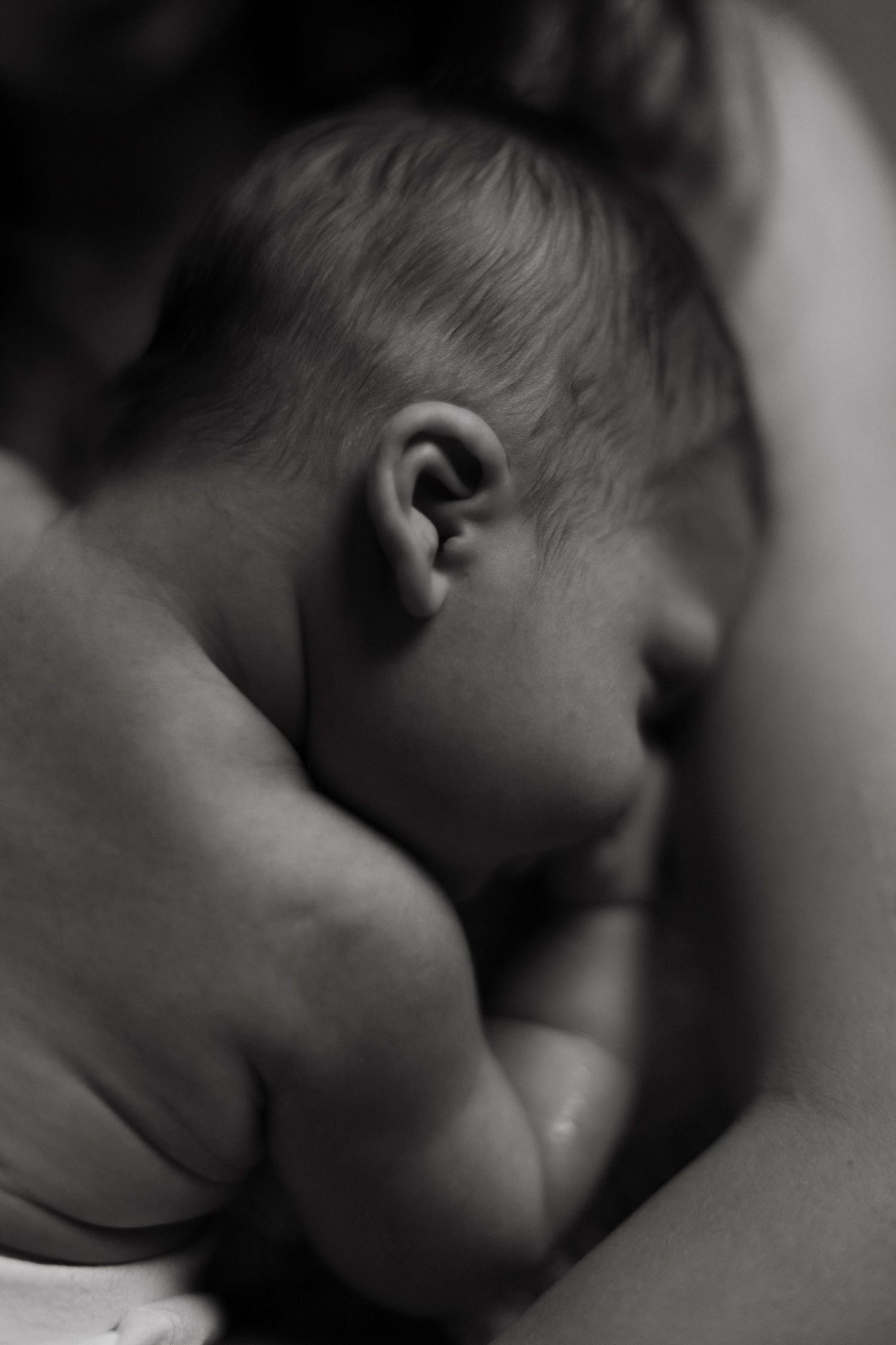 Close-up black and white portrait of sleeping infant showing peaceful expression.