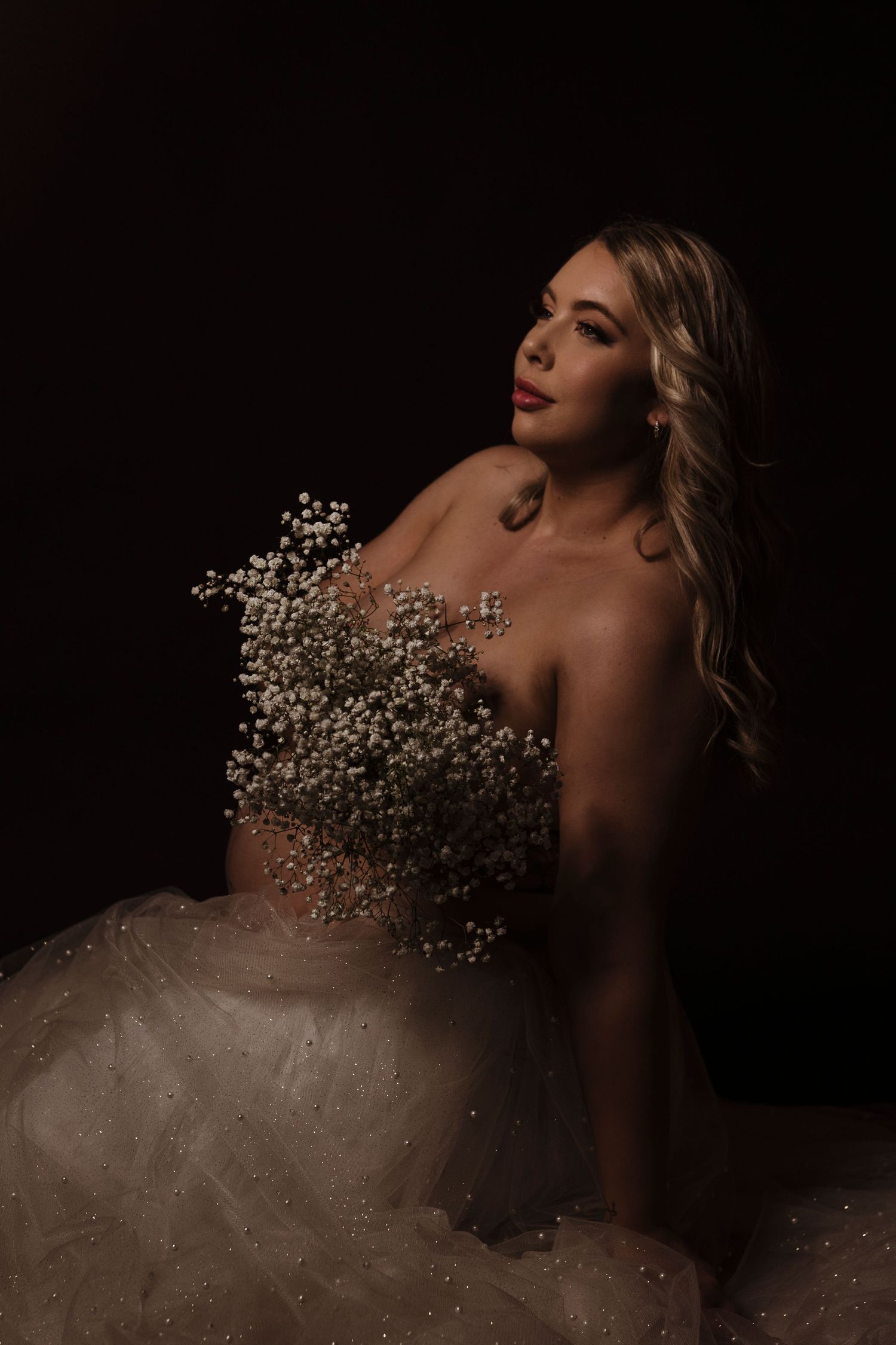 Artistic portrait series featuring delicate baby's breath flowers against dark backdrop.