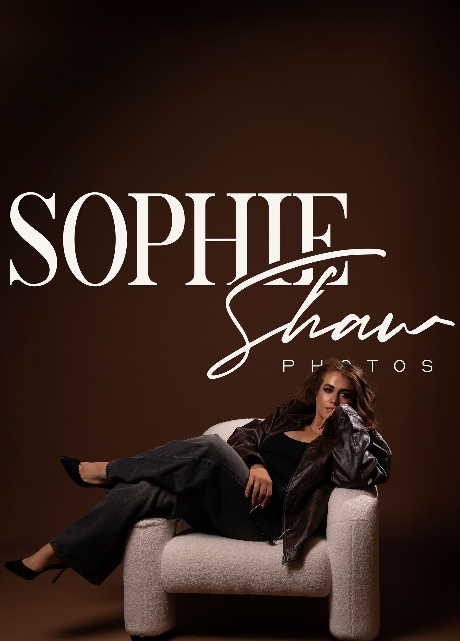A woman in black outfit reclines on a white chair against a brown background with Sophie Shaw Photos logo overlay.