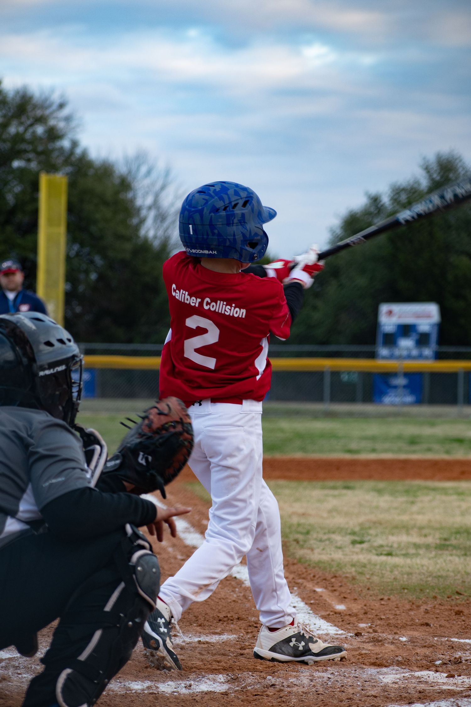 A baseball sequence showing a batter in red and white uniform at home plate getting ready to swing at the pitch.