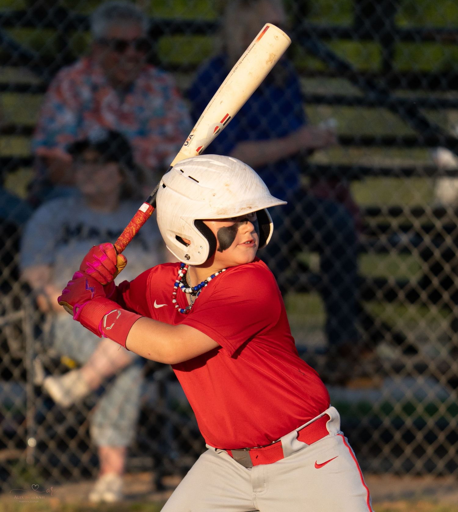 Baseball player in red jersey showing batting form sequence during game at MVP Sports facility.