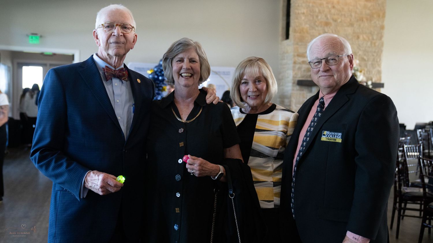 Group of attendees gathered at formal evening networking event.