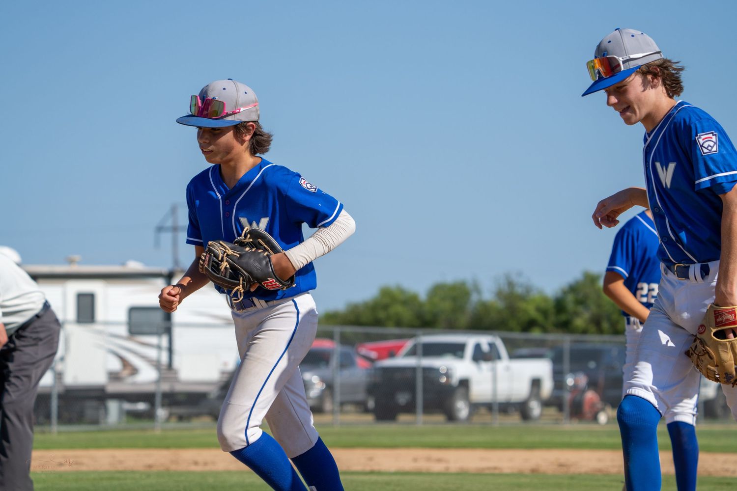 A baseball pitcher in blue and white uniform throws a pitch in sequential action shots showing the complete throwing motion.