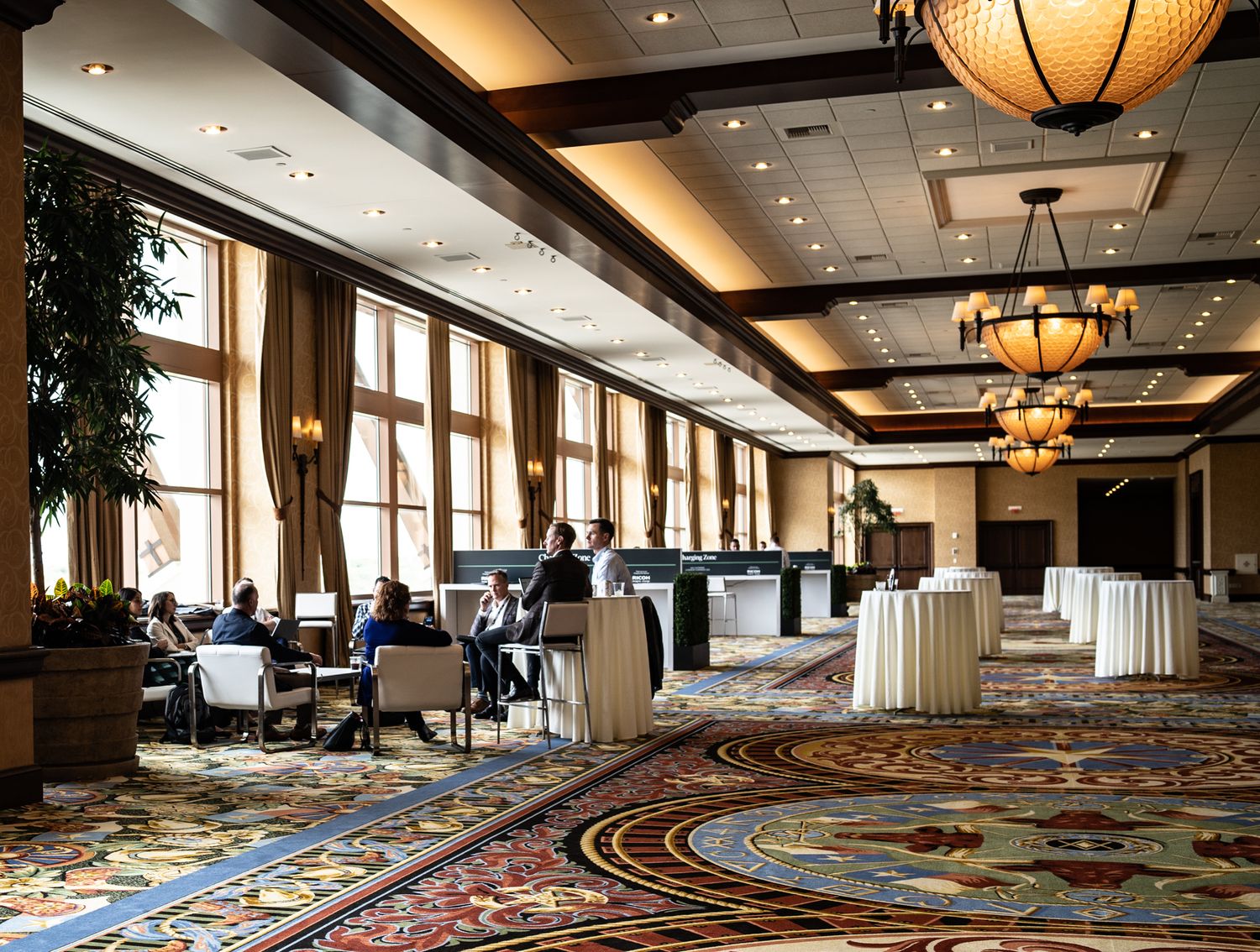 Empty conference room with elegant chandeliers and decorative carpeting at The Westin Galleria.