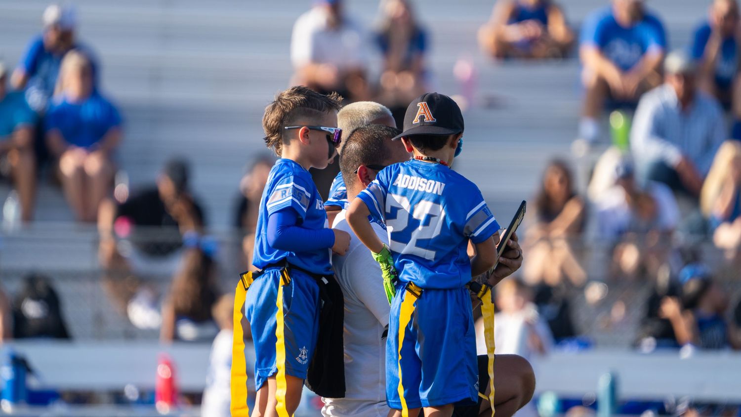 Players in blue and yellow jerseys face off during an intense moment of athletic competition.