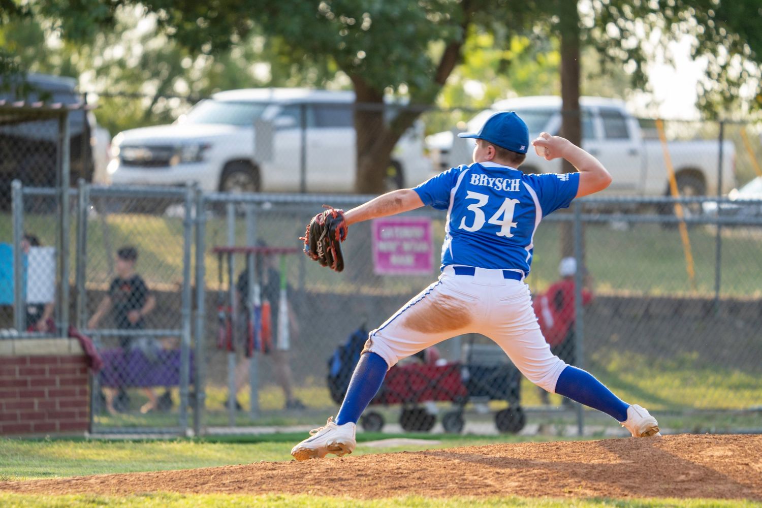 Baseball pitcher in blue jersey number 54 winds up to throw from the pitching mound during a game.