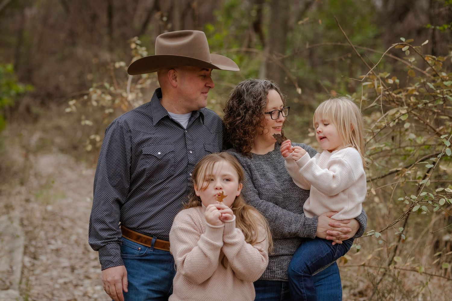 A collage of outdoor family portraits shows candid moments between adults and children in a natural wooded setting.