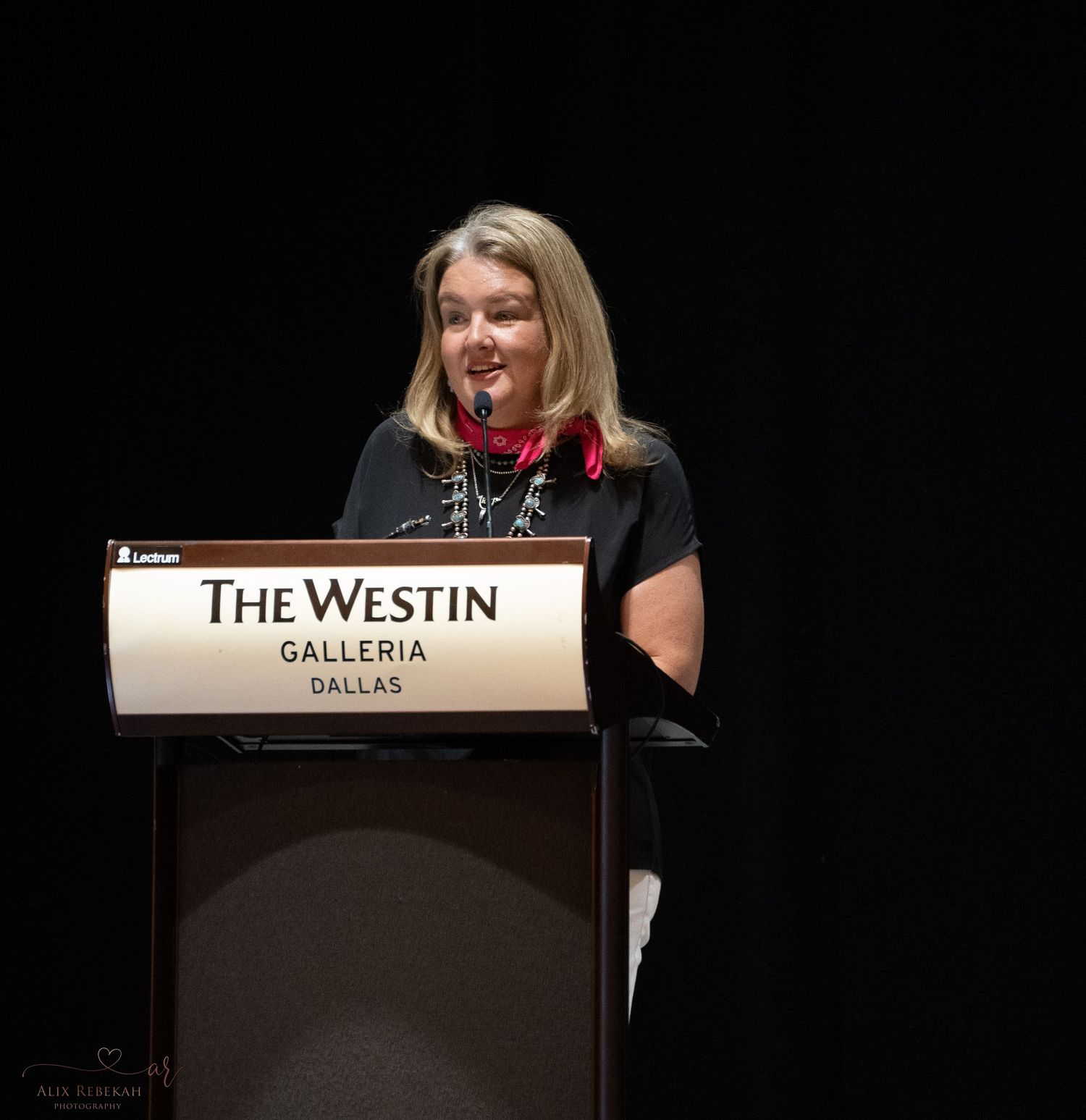 Presenter speaking at podium during The Westin Galleria Dallas event.