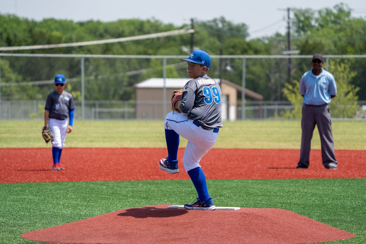 Six sequential frames show a baseball pitcher's throwing motion on a red dirt mound during a game on a sunny day.