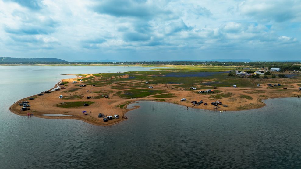 Aerial panorama of coastline showing sandy beaches and waterways from above.