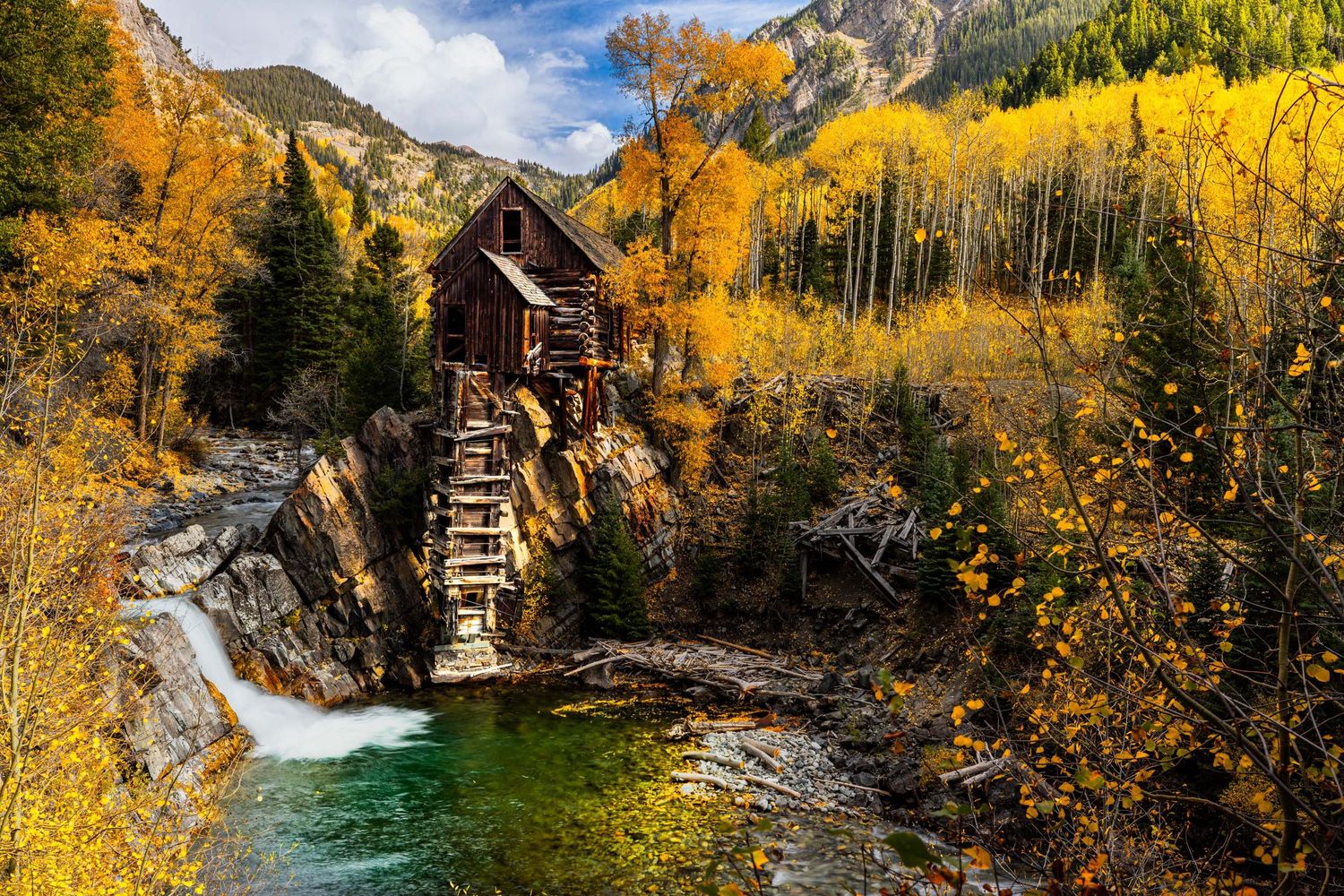 Crystal clear mountain stream surrounded by golden fall aspens and rocky peaks. The Crystal Mill near Mable, Colorado