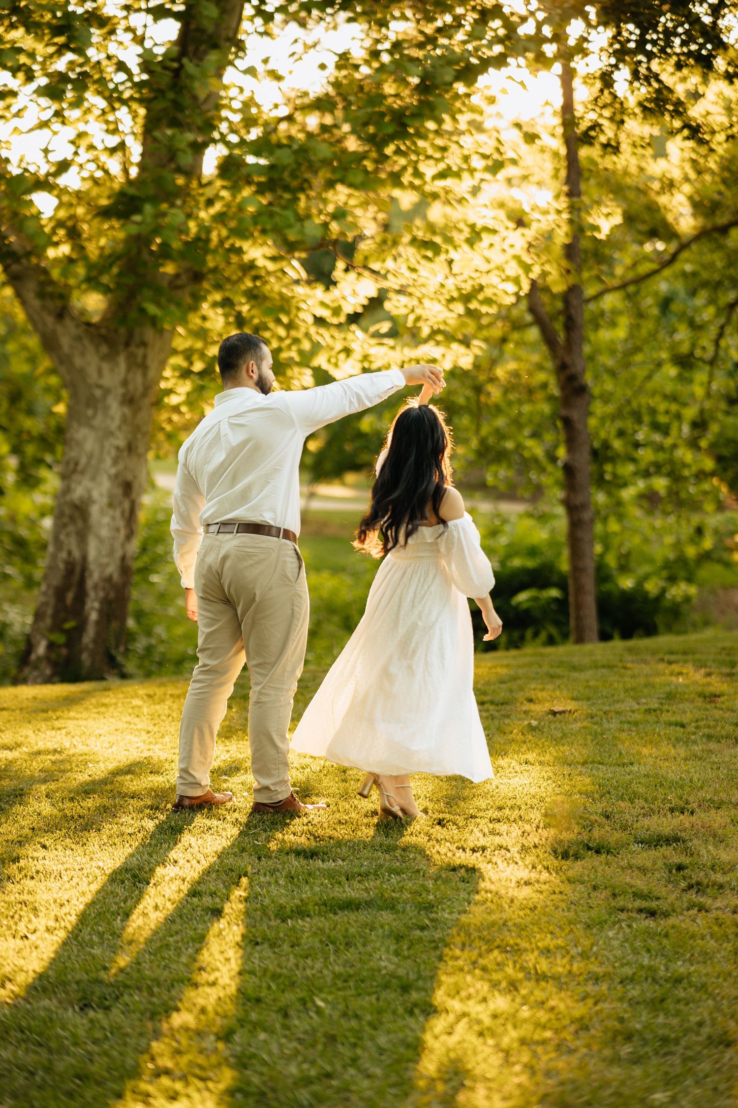 Fiance's being photographed in the part during golden hour. Engagement session at the park.