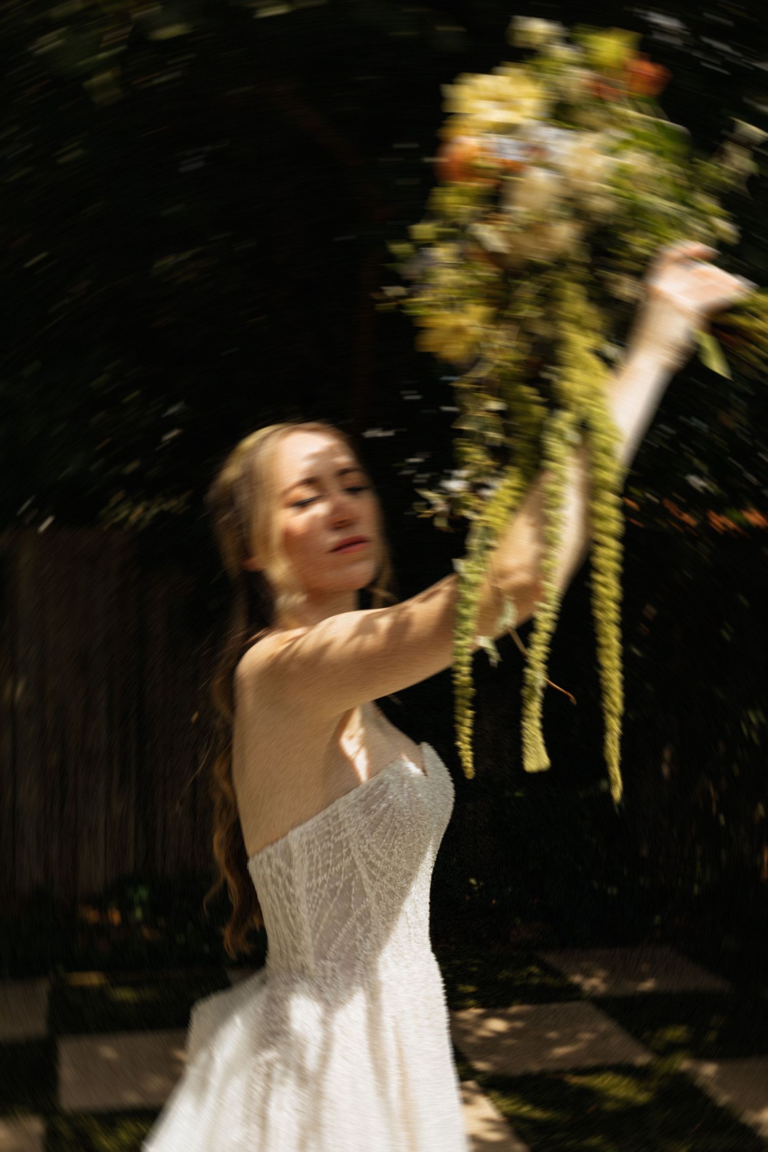 Bride posing in a white dress in an editorial manner during her wedding day.