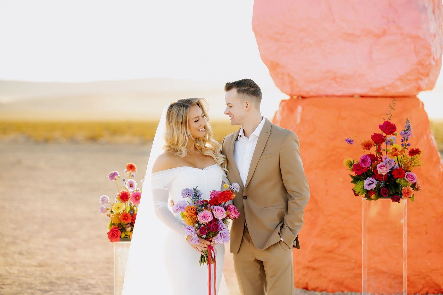 Las Vegas bride and groom posing in an editorial manner. Wedding ceremony held at seven magic mountains in las vegas, nevada.