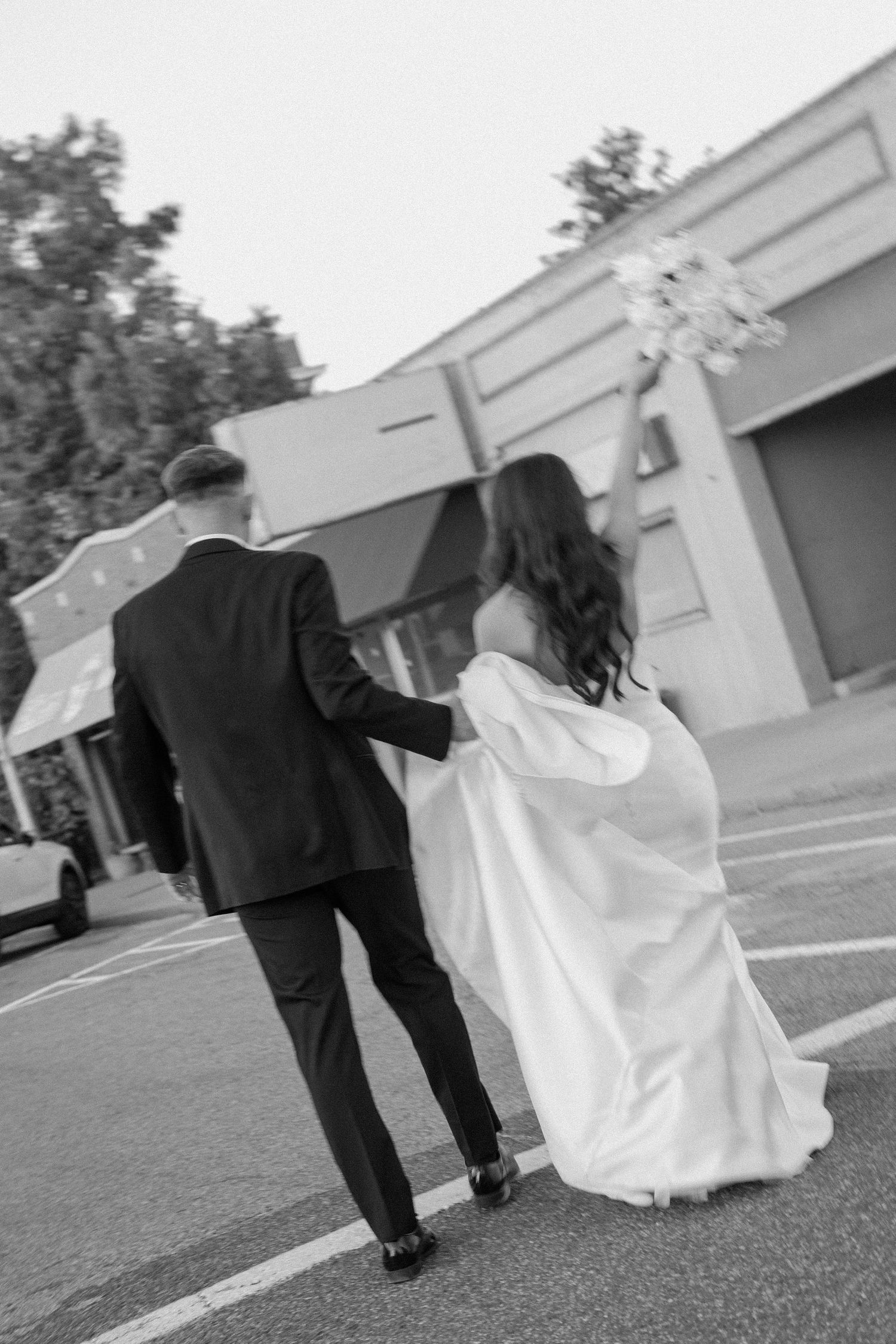Bride and groom posing in an editorial manner during their wedding day.