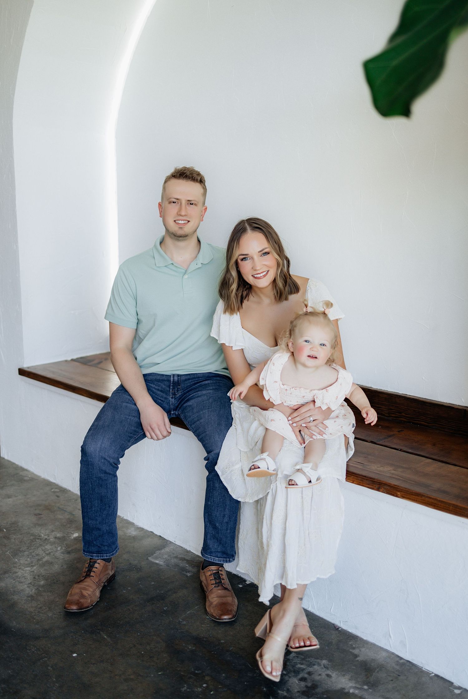 Family of three posing for a family photo during an in-studio family session.