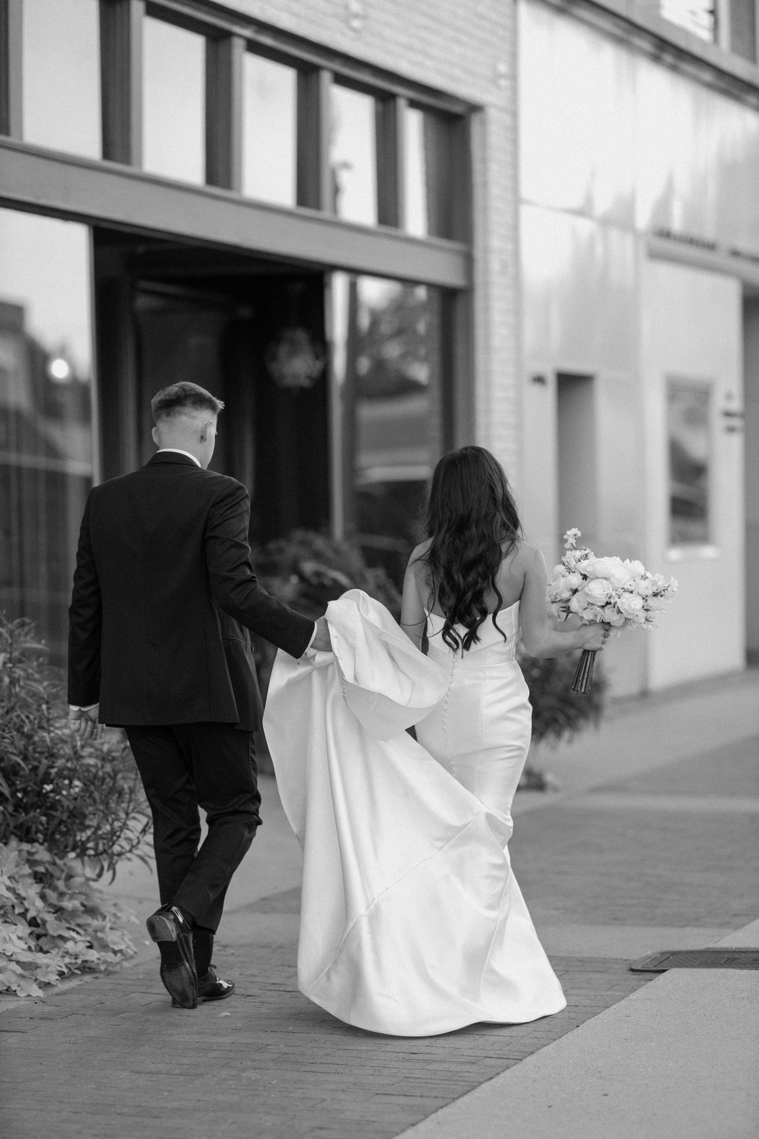 Bride and groom posing in an editorial manner during their wedding day.