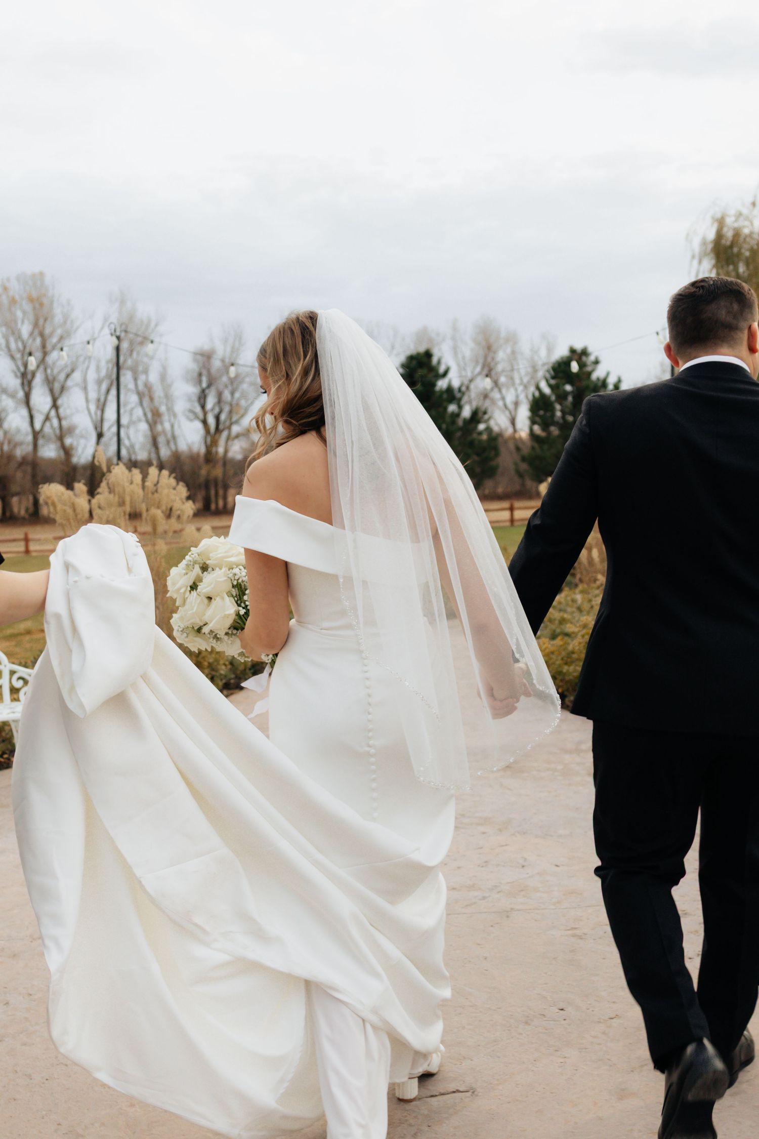 Bride and groom posing in an editorial manner during their wedding day.