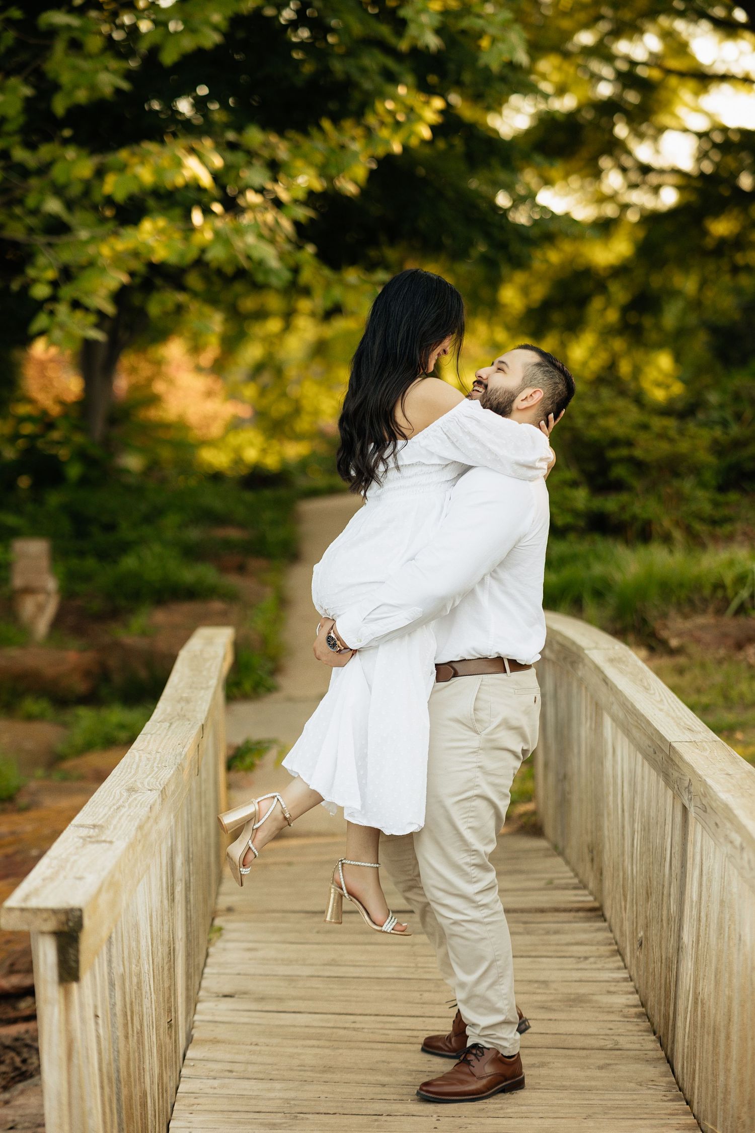 Fiance's being photographed in the part during golden hour. Engagement session at the park.