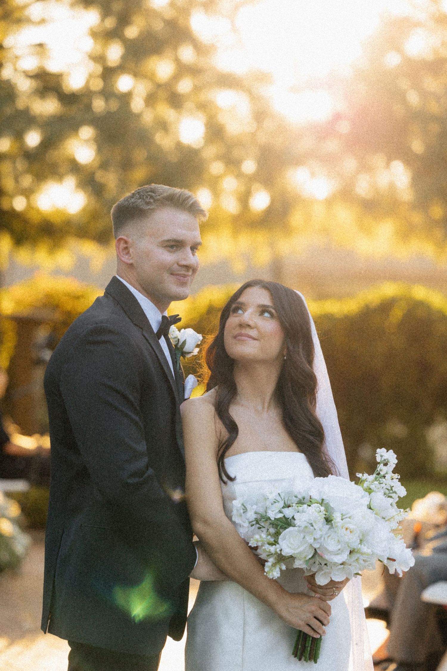 Candid photo of a bride and groom during golden hour.