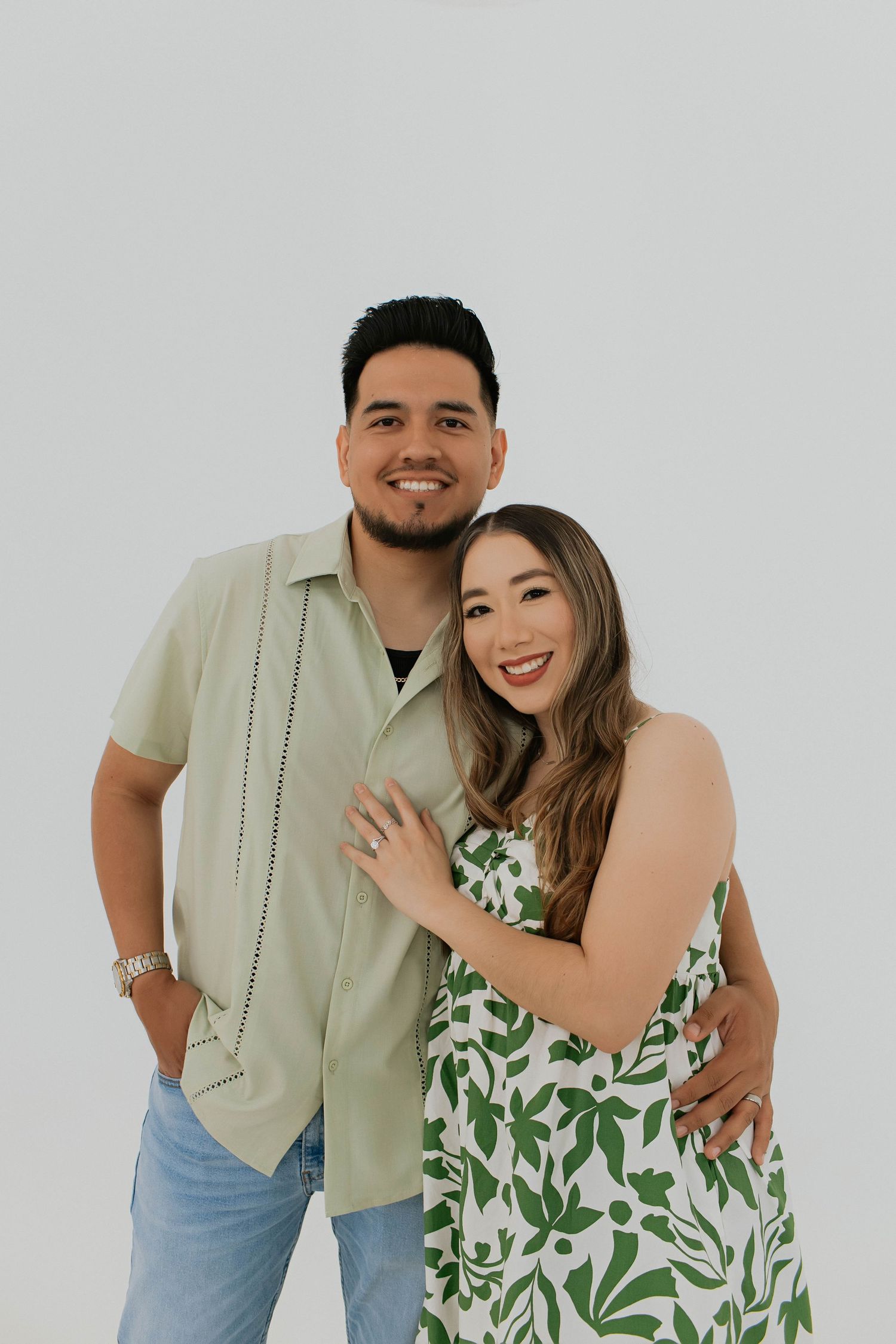 Husband and wife. White and green dress with flowers. Long hair. Hispanic couple. Mom and dad photos.