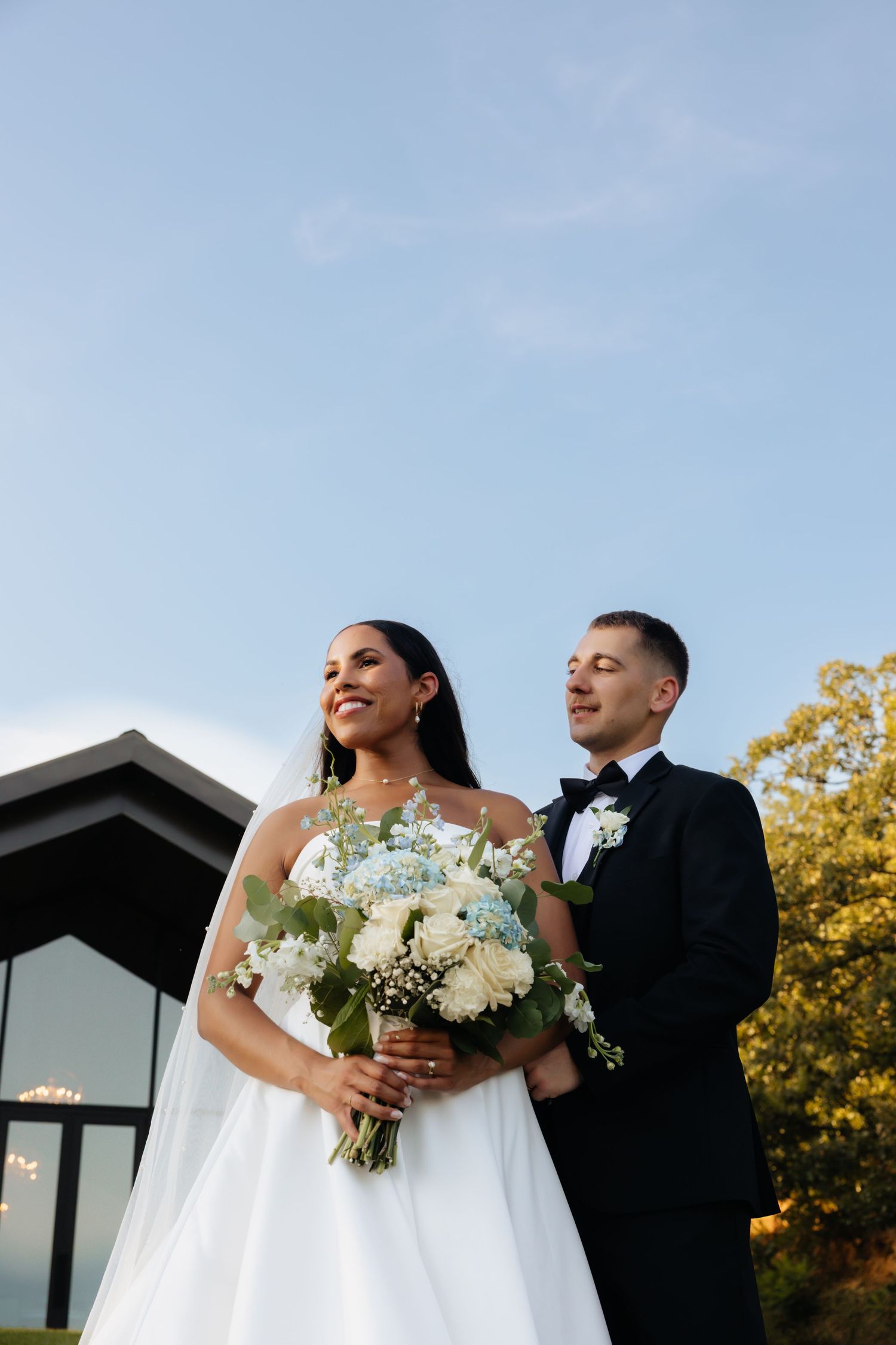 Bride and groom posing in an editorial manner during their wedding day.