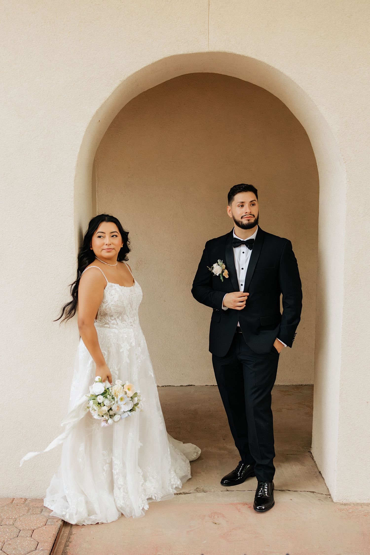 Bride and groom posing in an editorial manner during their wedding day.