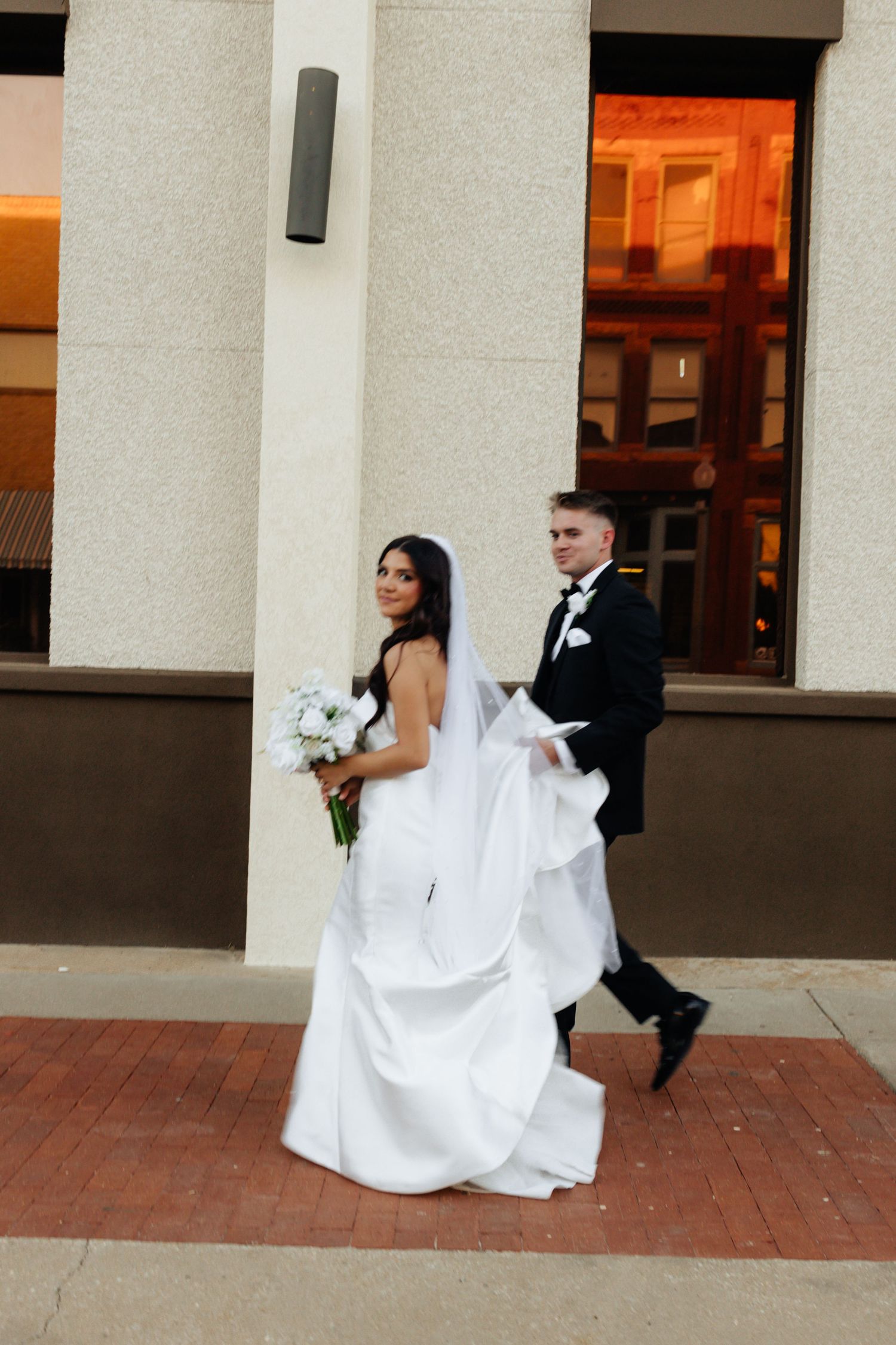 Bride and groom posing in an editorial manner during their wedding day.