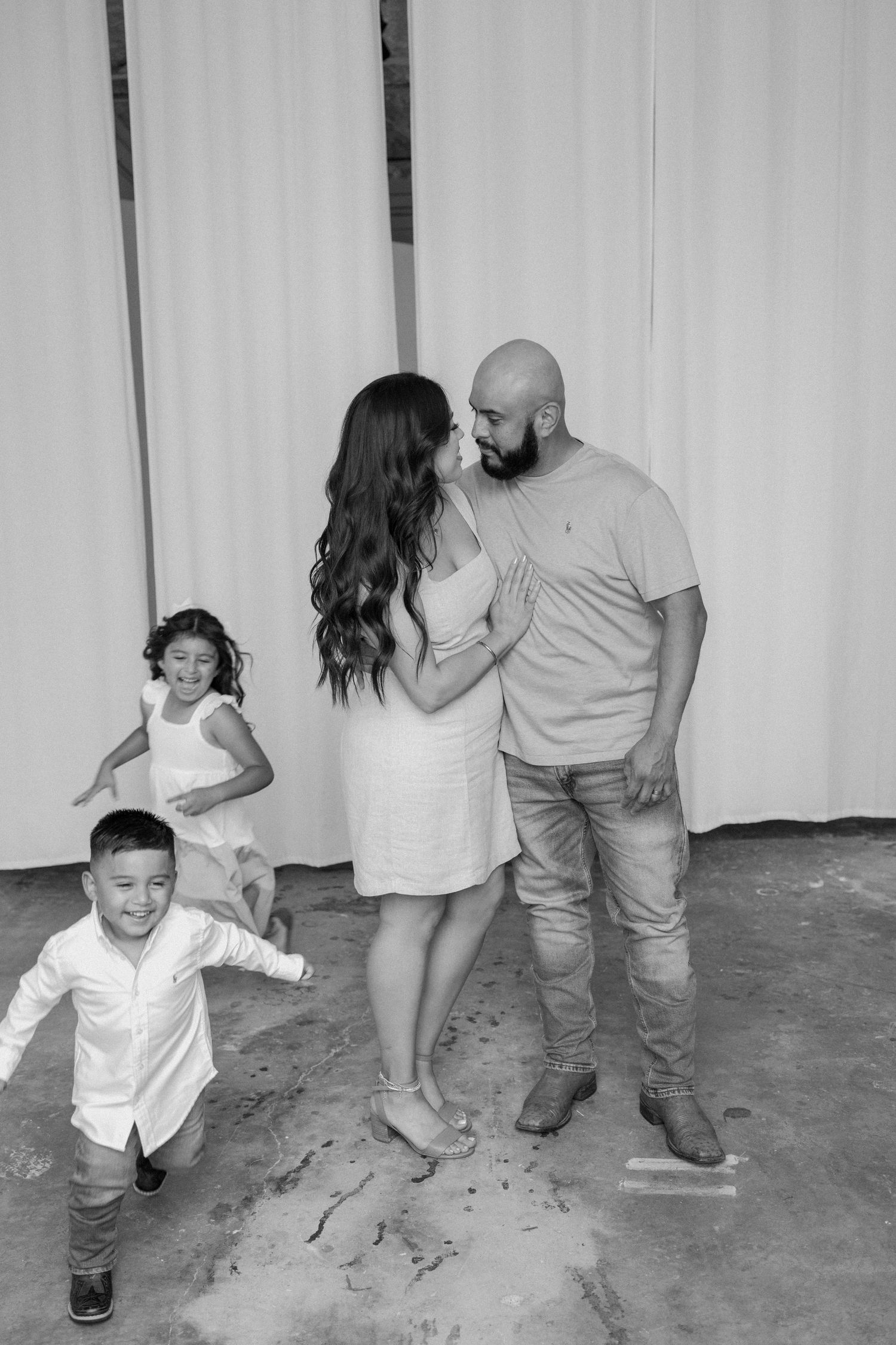 Family of four posing for a family photo during an in-studio family session.