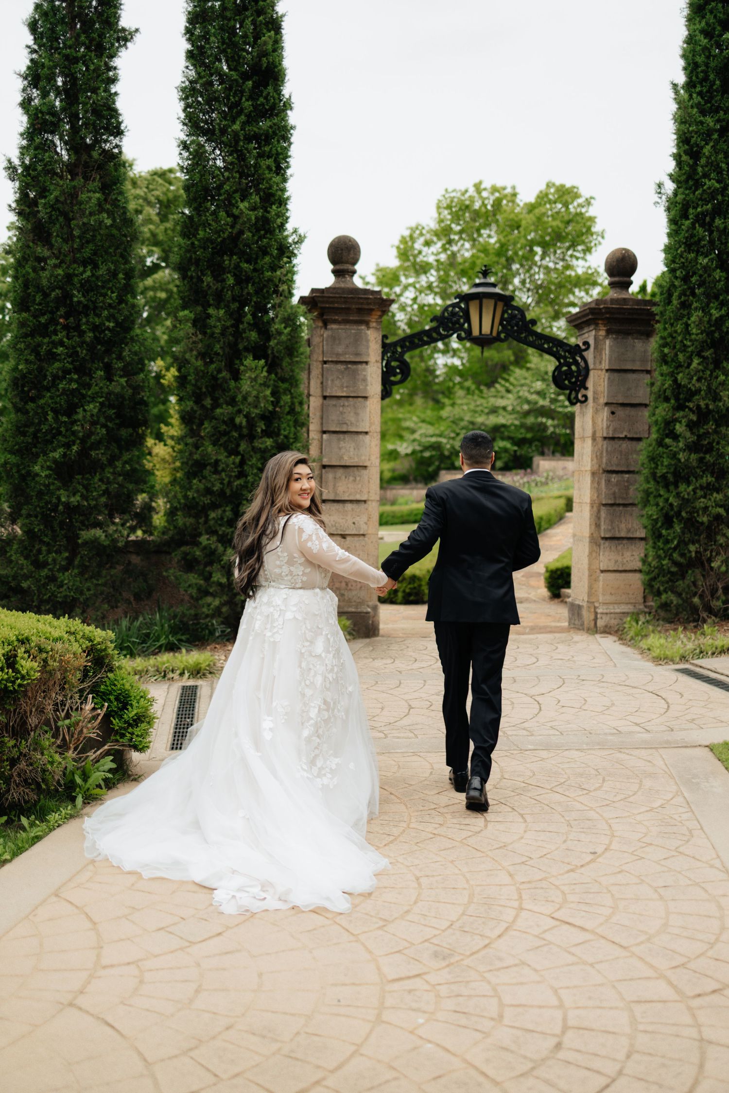 Bride and groom posing in an editorial manner during their wedding day.