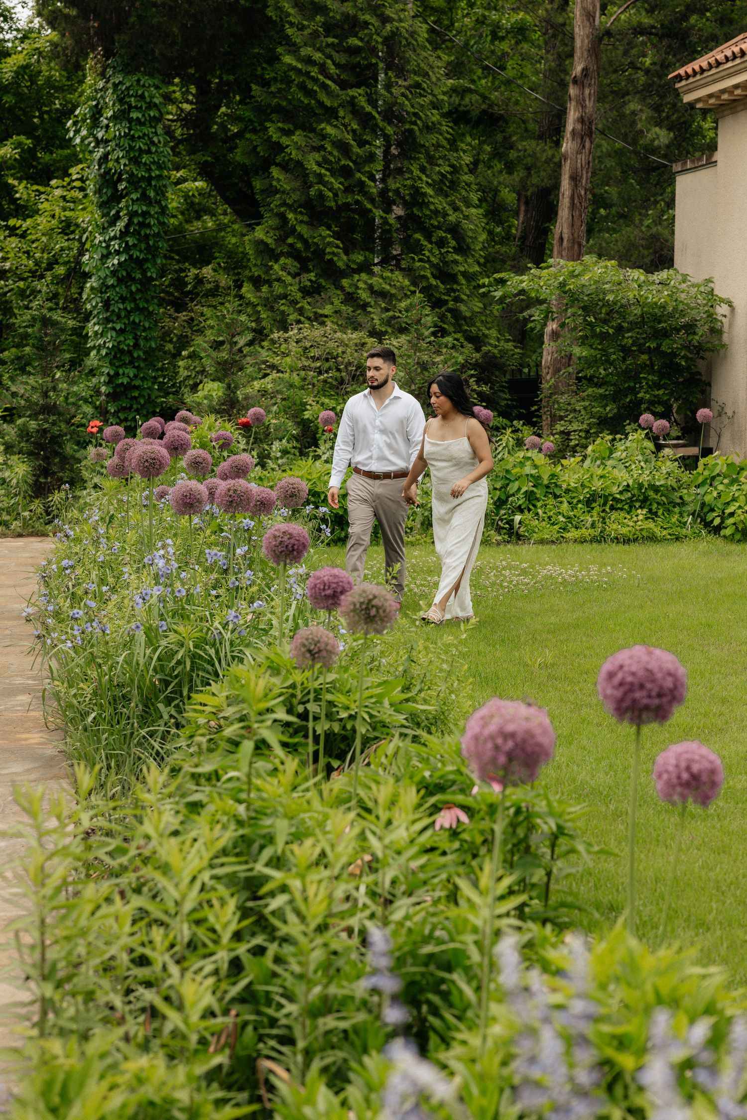 couple in a garden. Engagement session inspiration. Philbrook museum of art, tulsa Oklahoma. Bride and groom. purple spring flowers